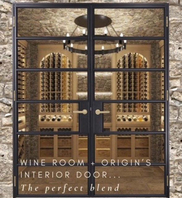 Wine room with glass doors, stone walls, and a chandelier.