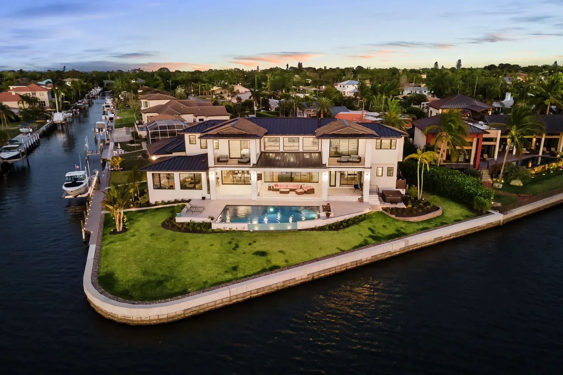 Luxurious waterfront home with pool and boat dock.