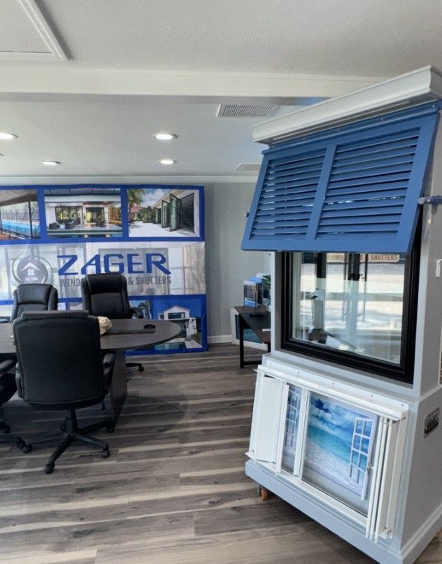 Interior showroom with Zager signage; display with blue shutters and a window.