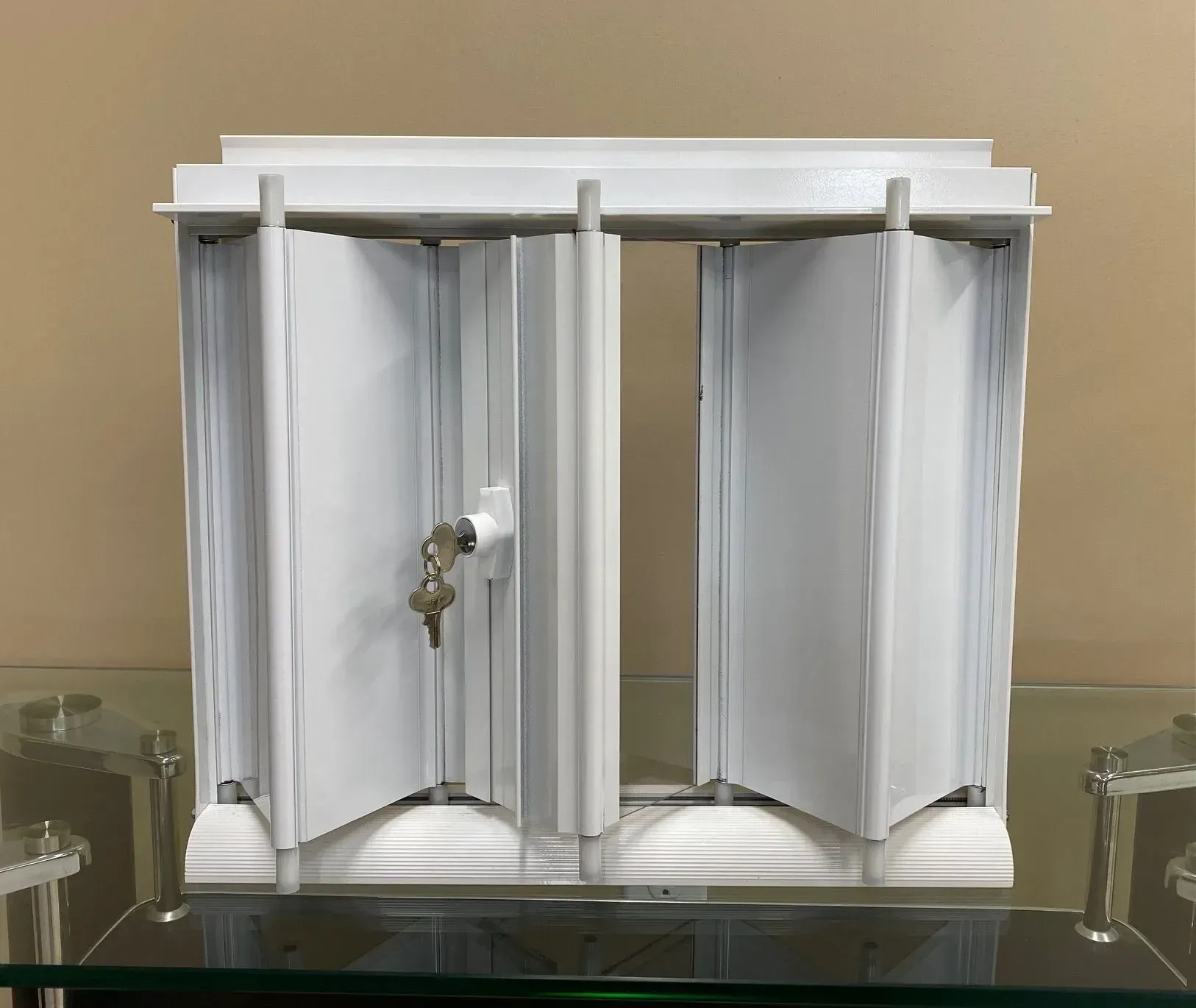 White security window with a key, set on a glass surface.