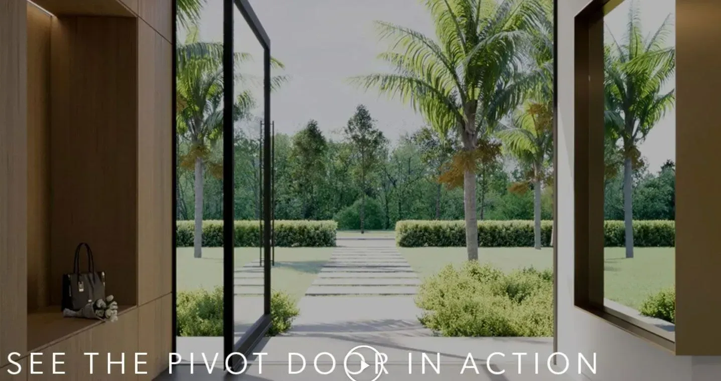 Open pivot door reveals a lush garden with trees. Interior view of a modern home.