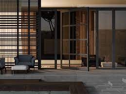 Patio with dark-framed glass doors, a seating area, and wooden slats for privacy.