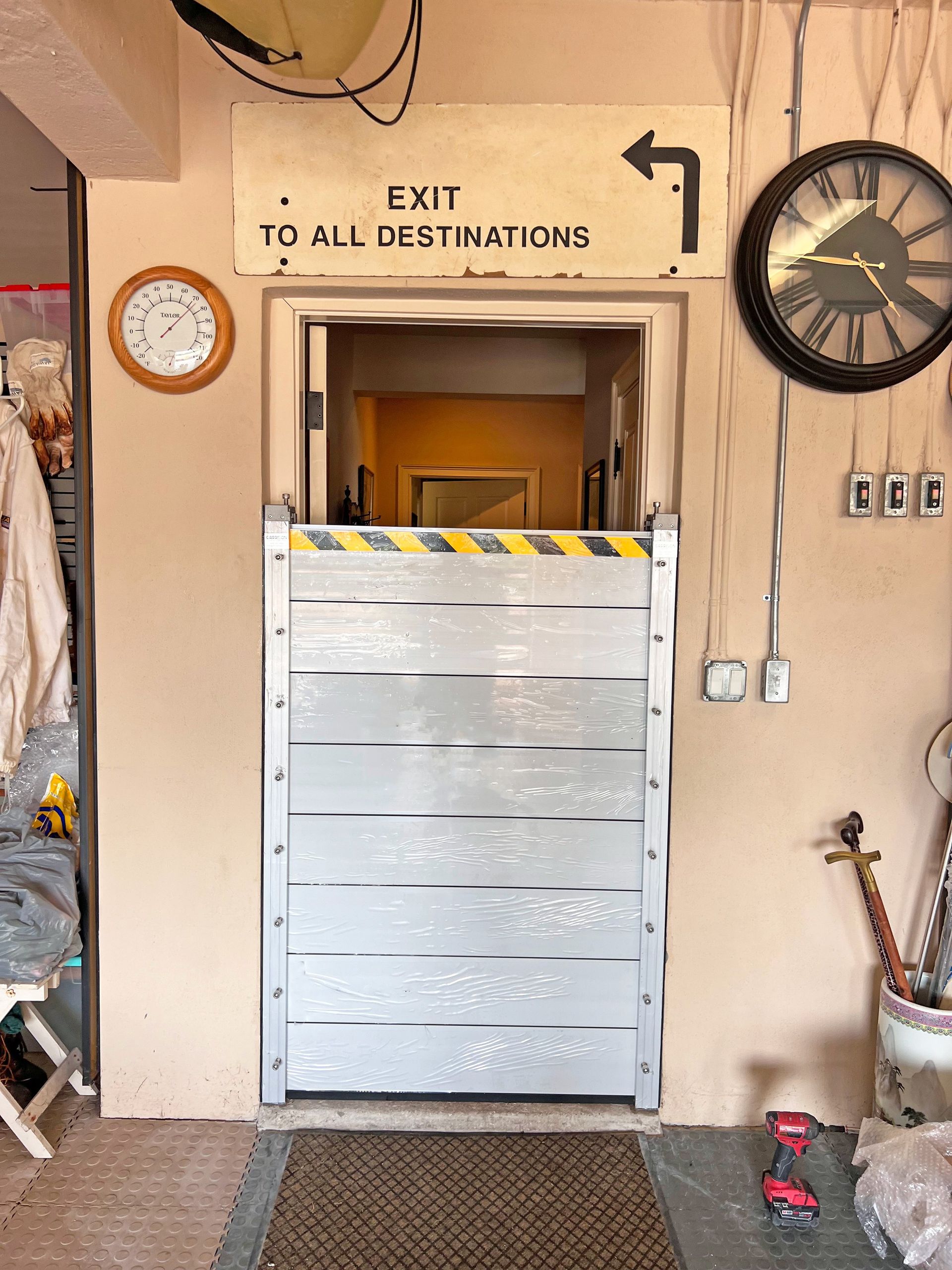 Doorway with metal flood barrier, sign