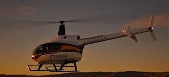 Helicopter in flight against a dusky sky.