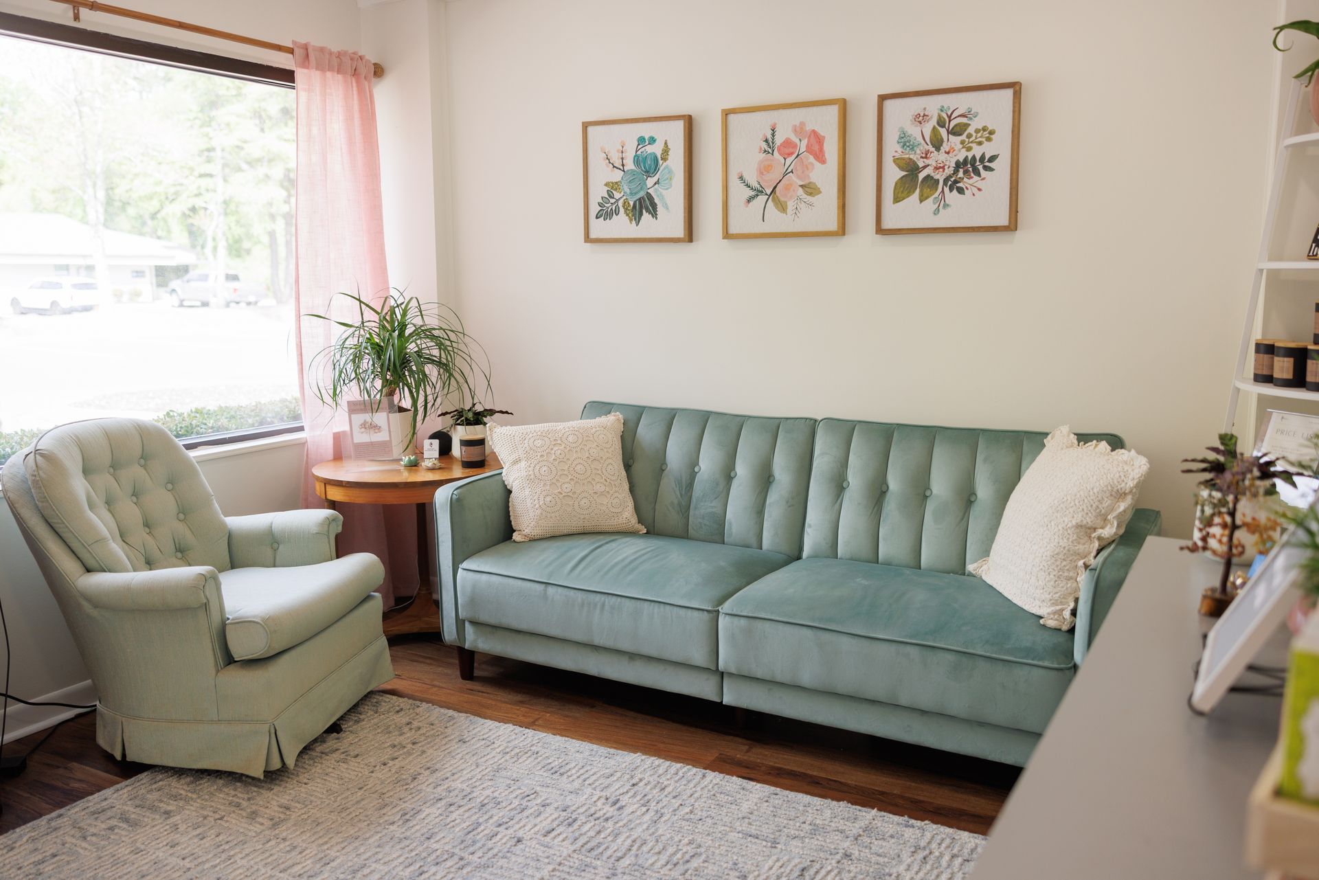 A white brick building with a black sign on the side of it