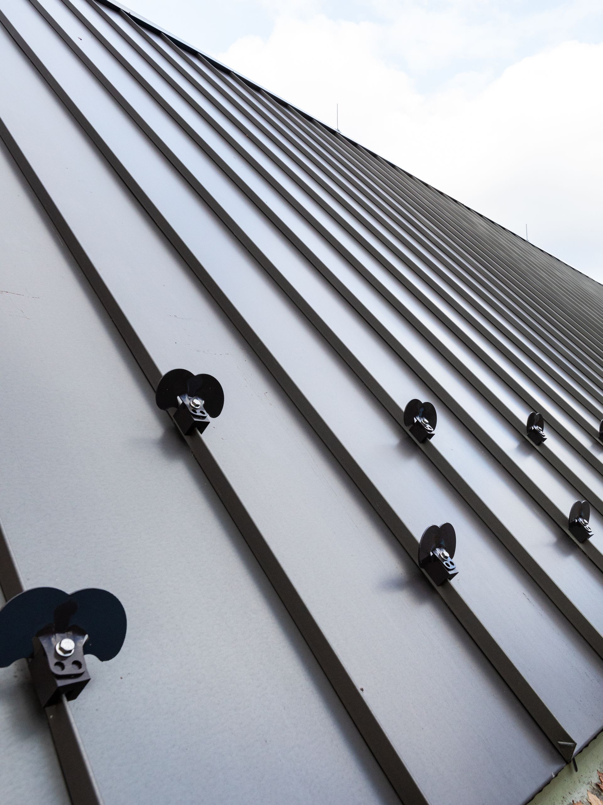 A close up of a metal roof with screws on it