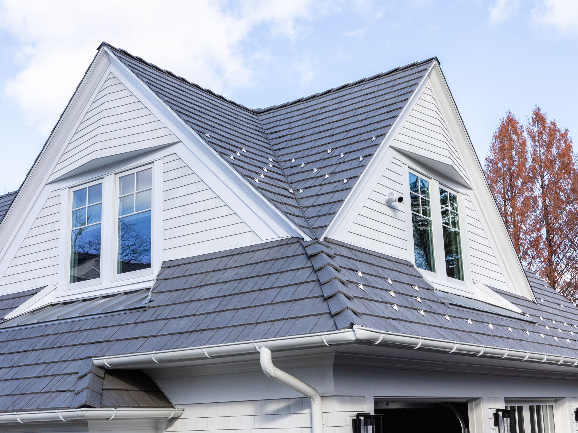 A white house with a gray roof and two windows