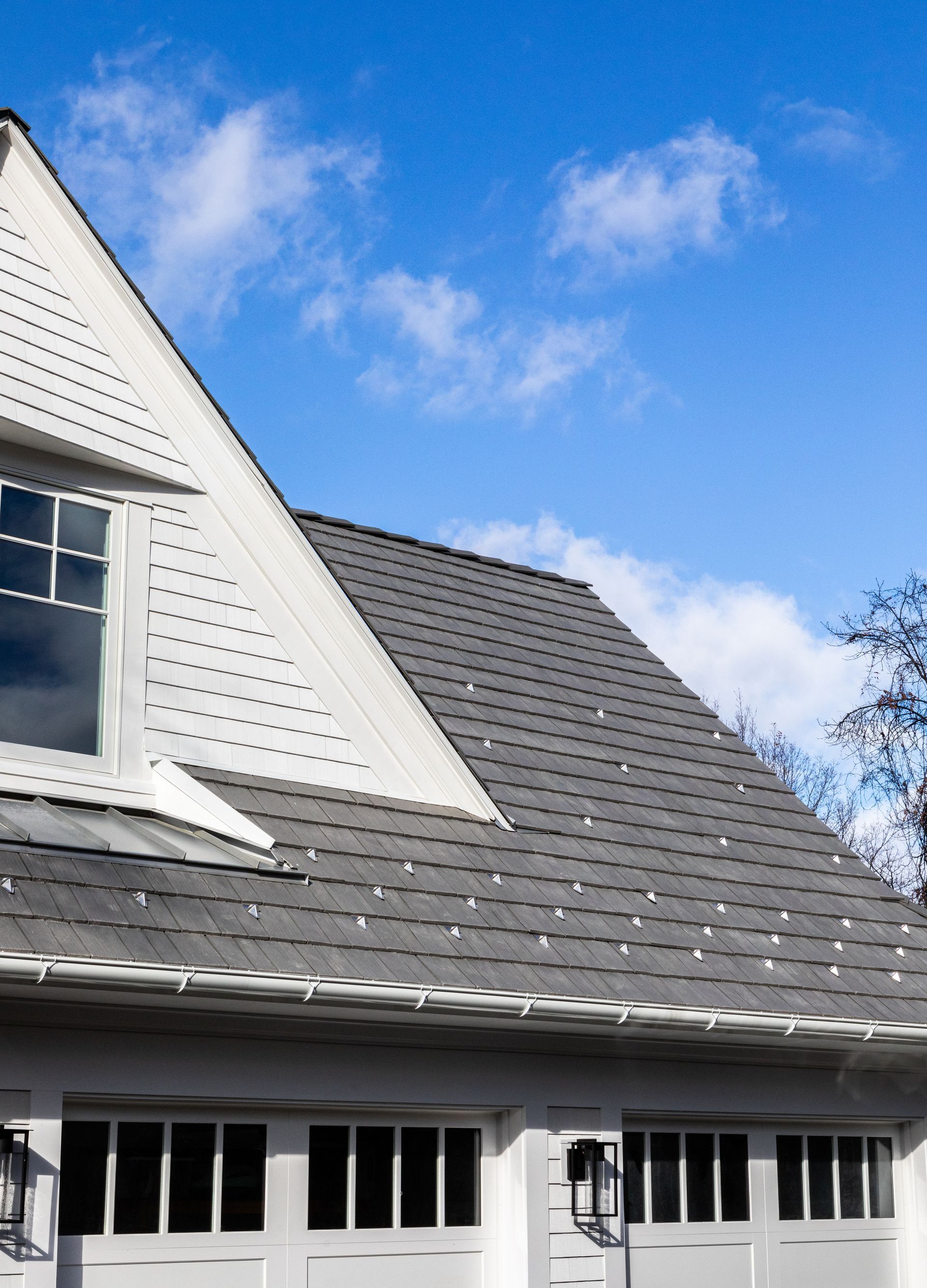A white house with a gray roof and a window