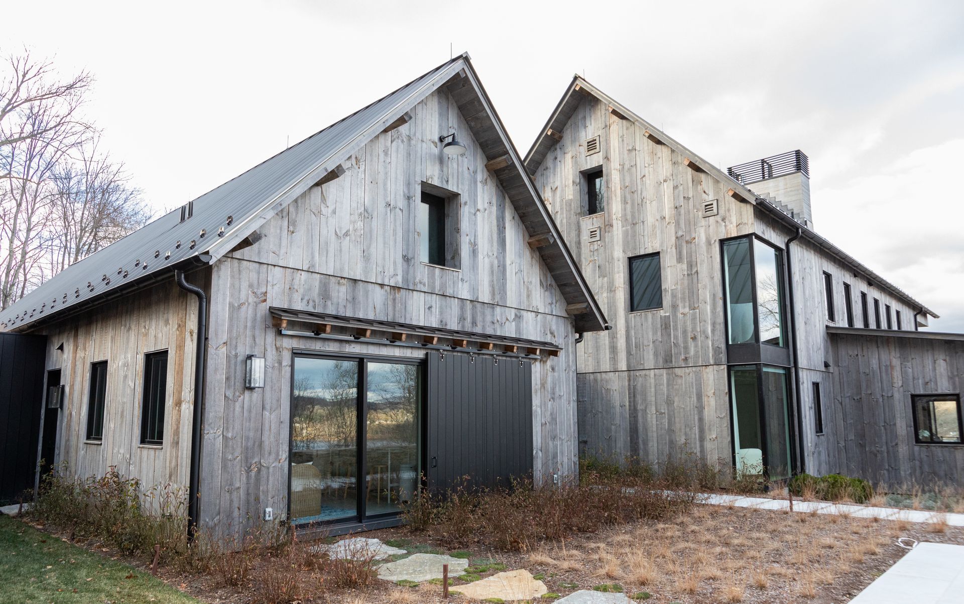 A large wooden house with a lot of windows and a gray roof.