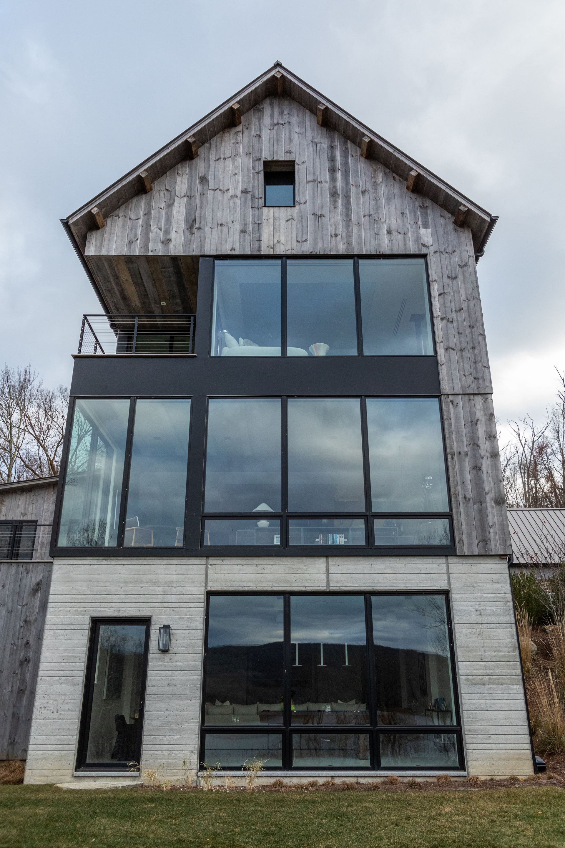 A large house with a lot of windows and a wooden roof.