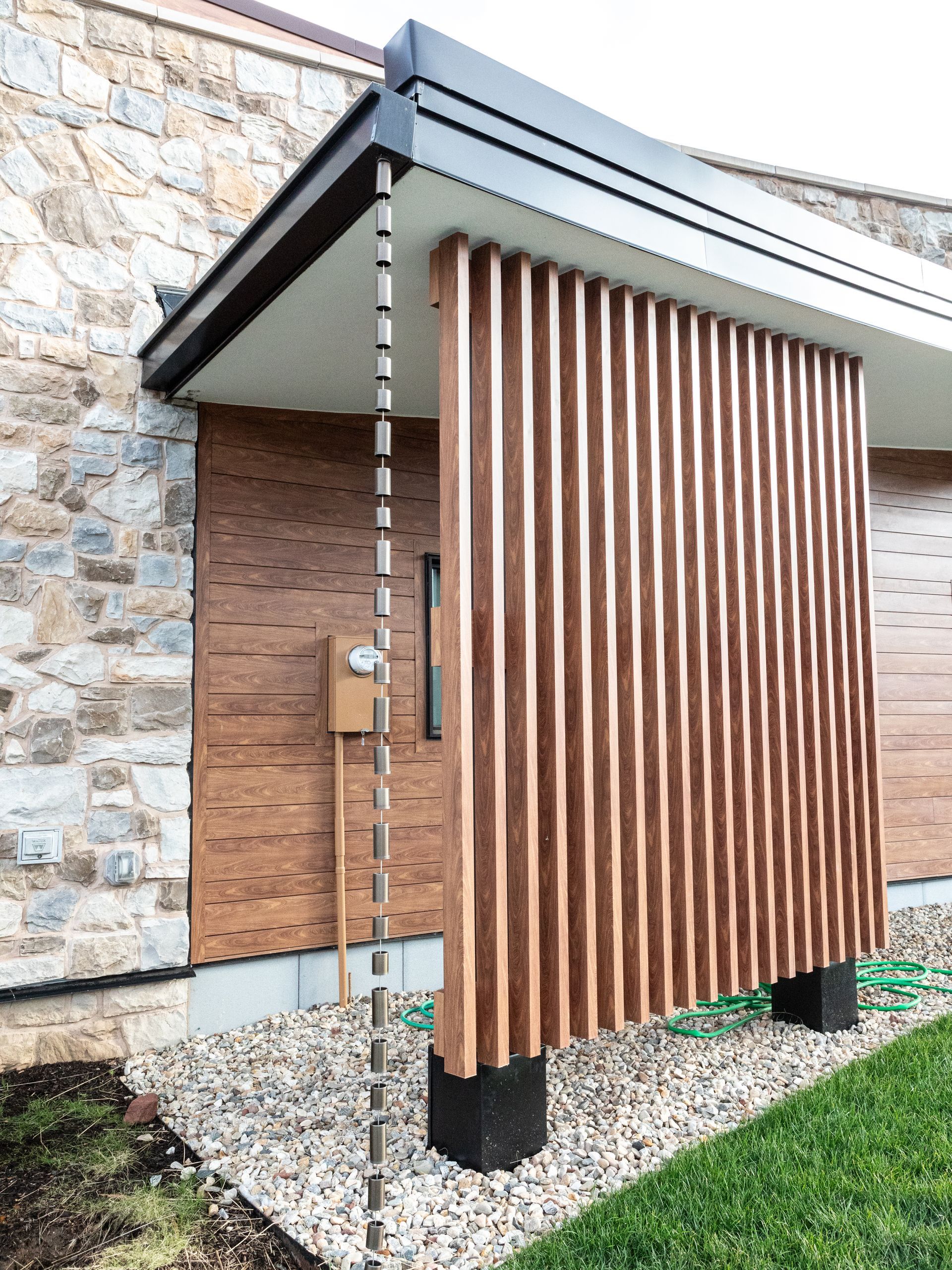 A house with a wooden porch and a mailbox on the side