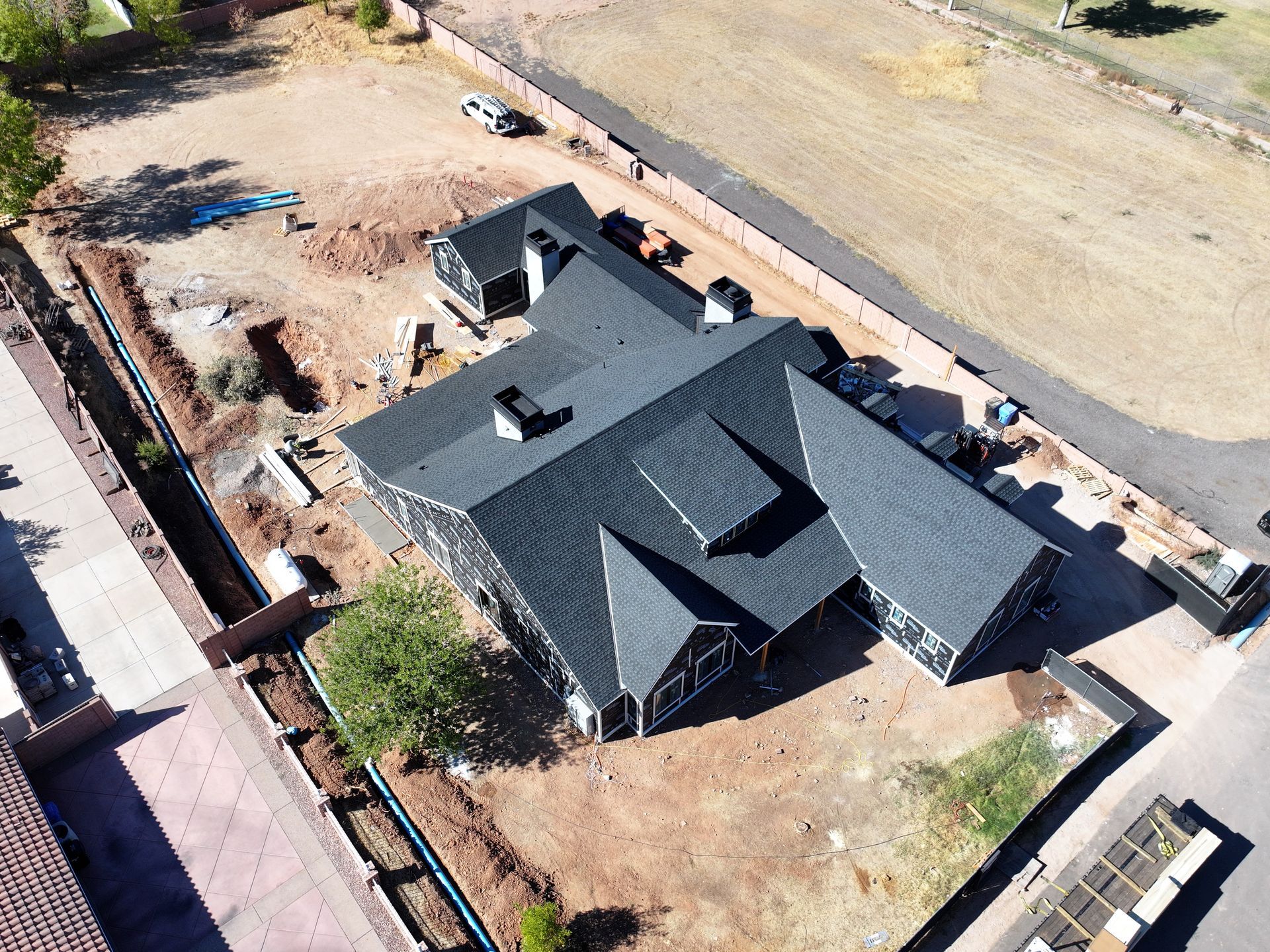 an aerial view of a house under construction with a black roof