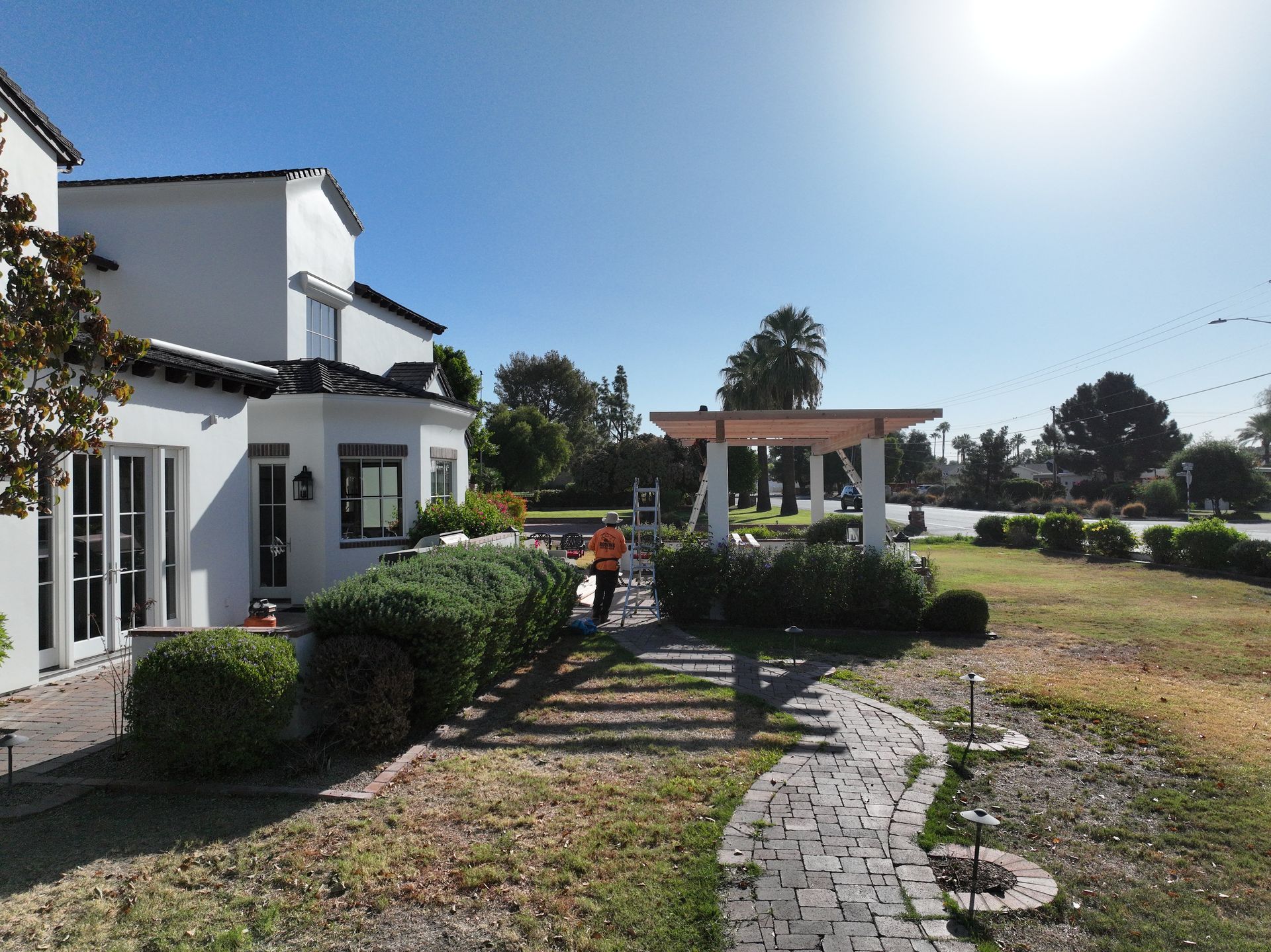 a white house with a brick walkway leading to it