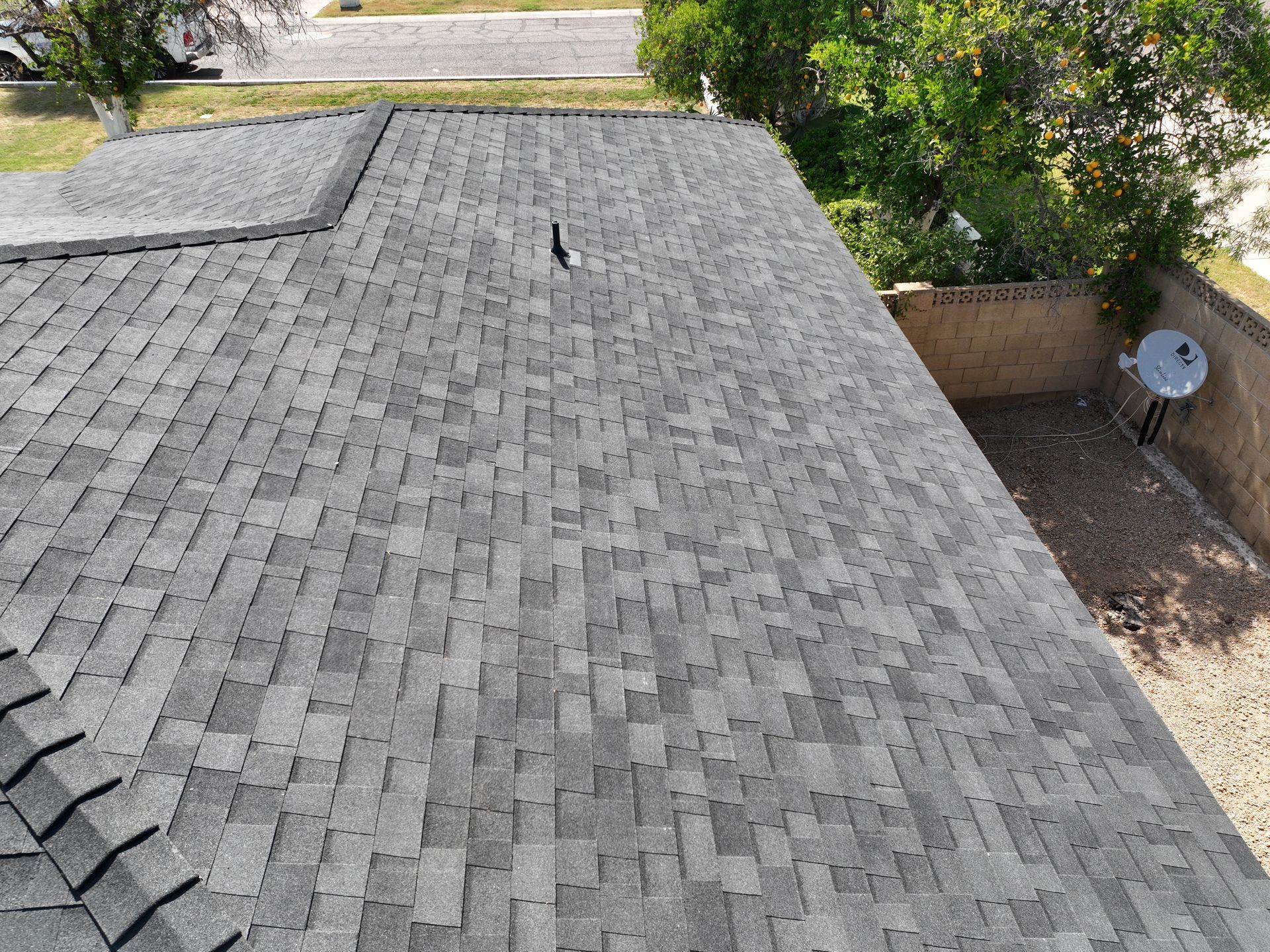 a roof with a satellite dish on it and a bird on it