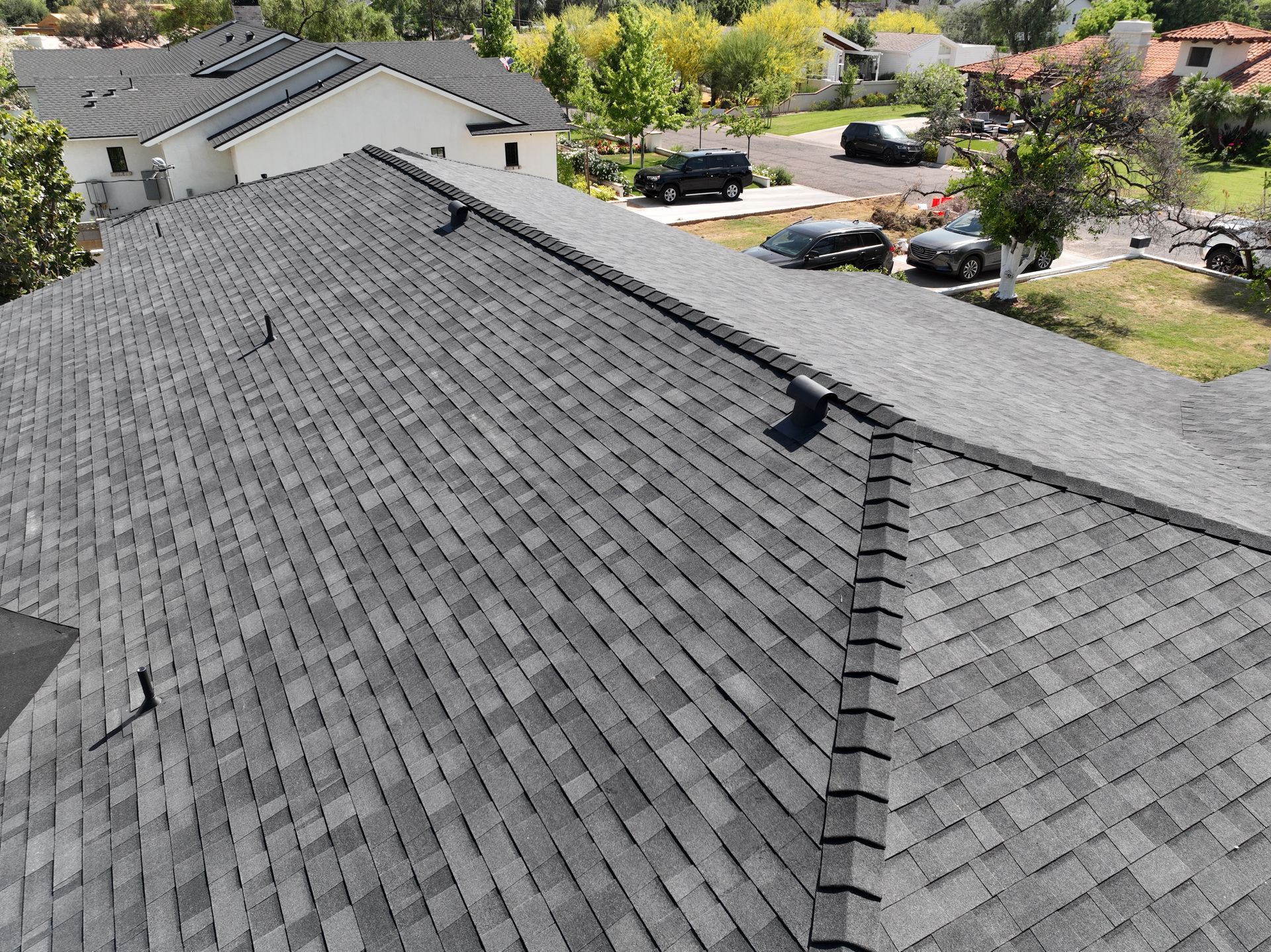 an aerial view of a roof of a house in a residential area