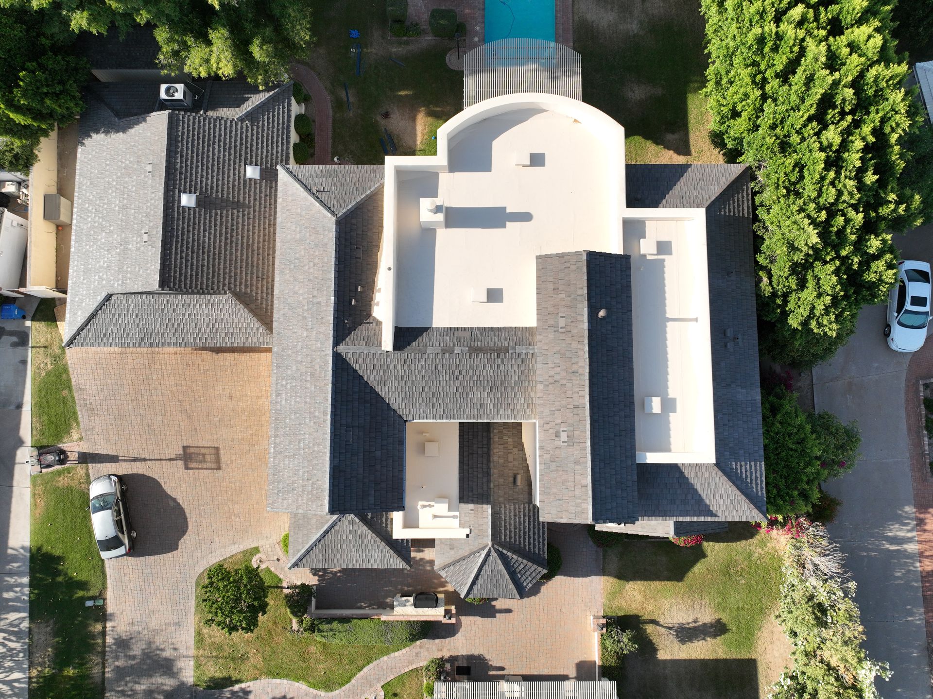 an aerial view of a large house with a pool