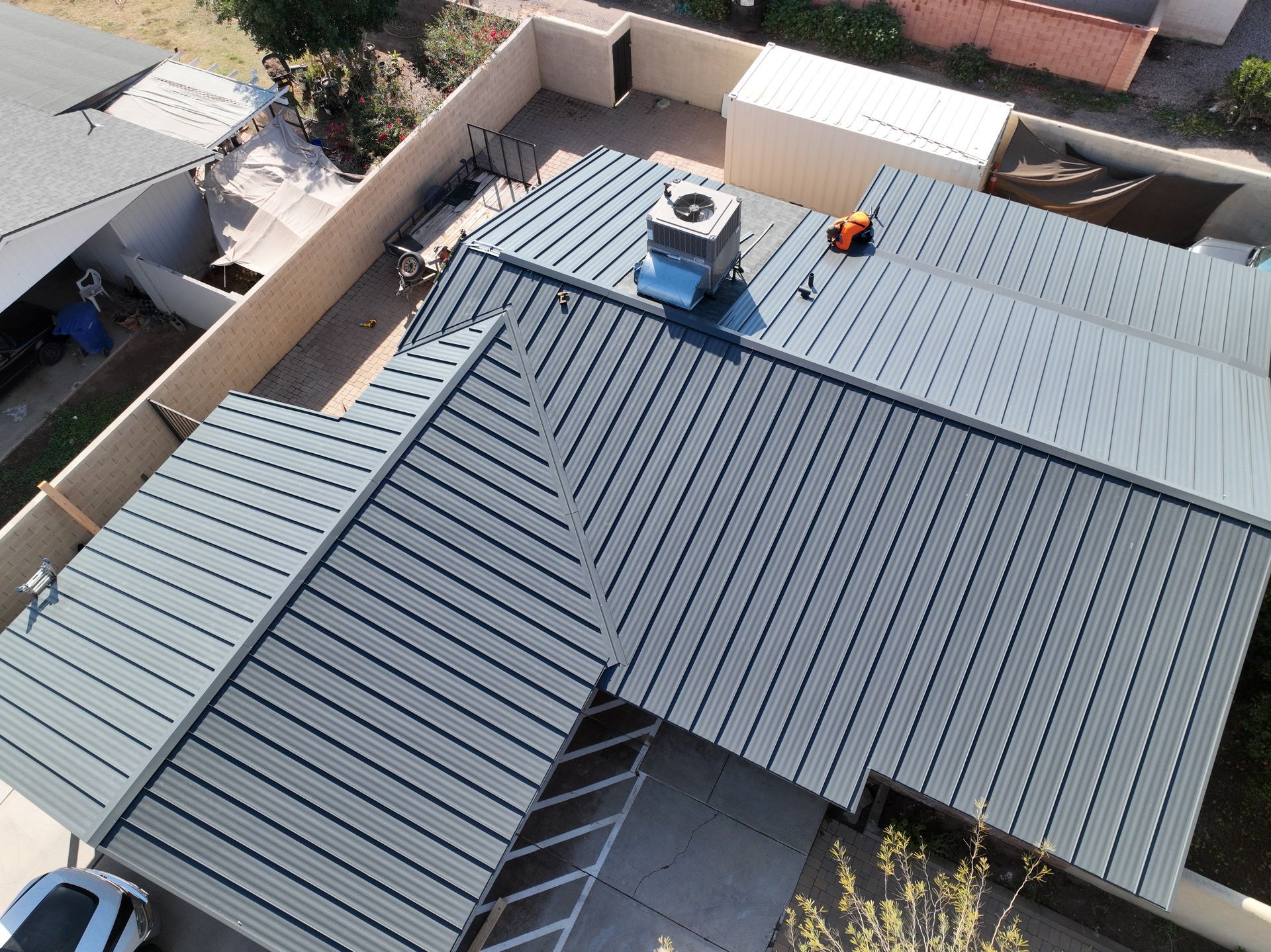 an aerial view of a house with a metal roof