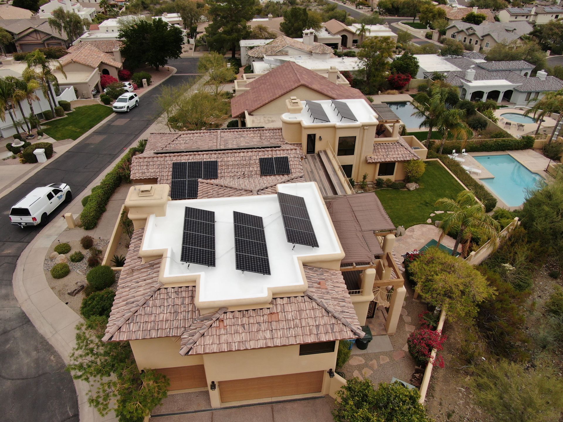 an aerial view of a house with solar panels on the roof