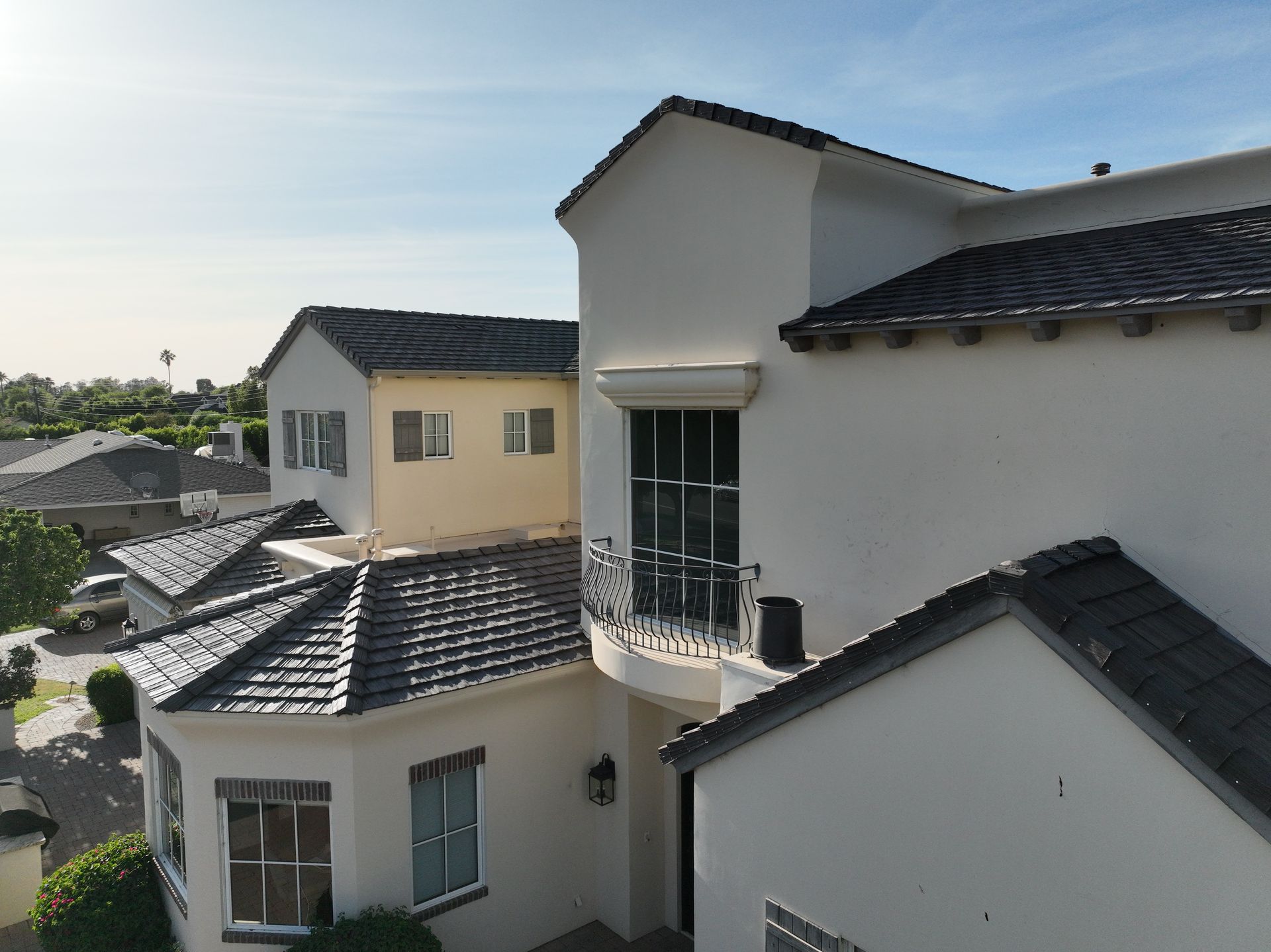 an aerial view of a white house with a balcony