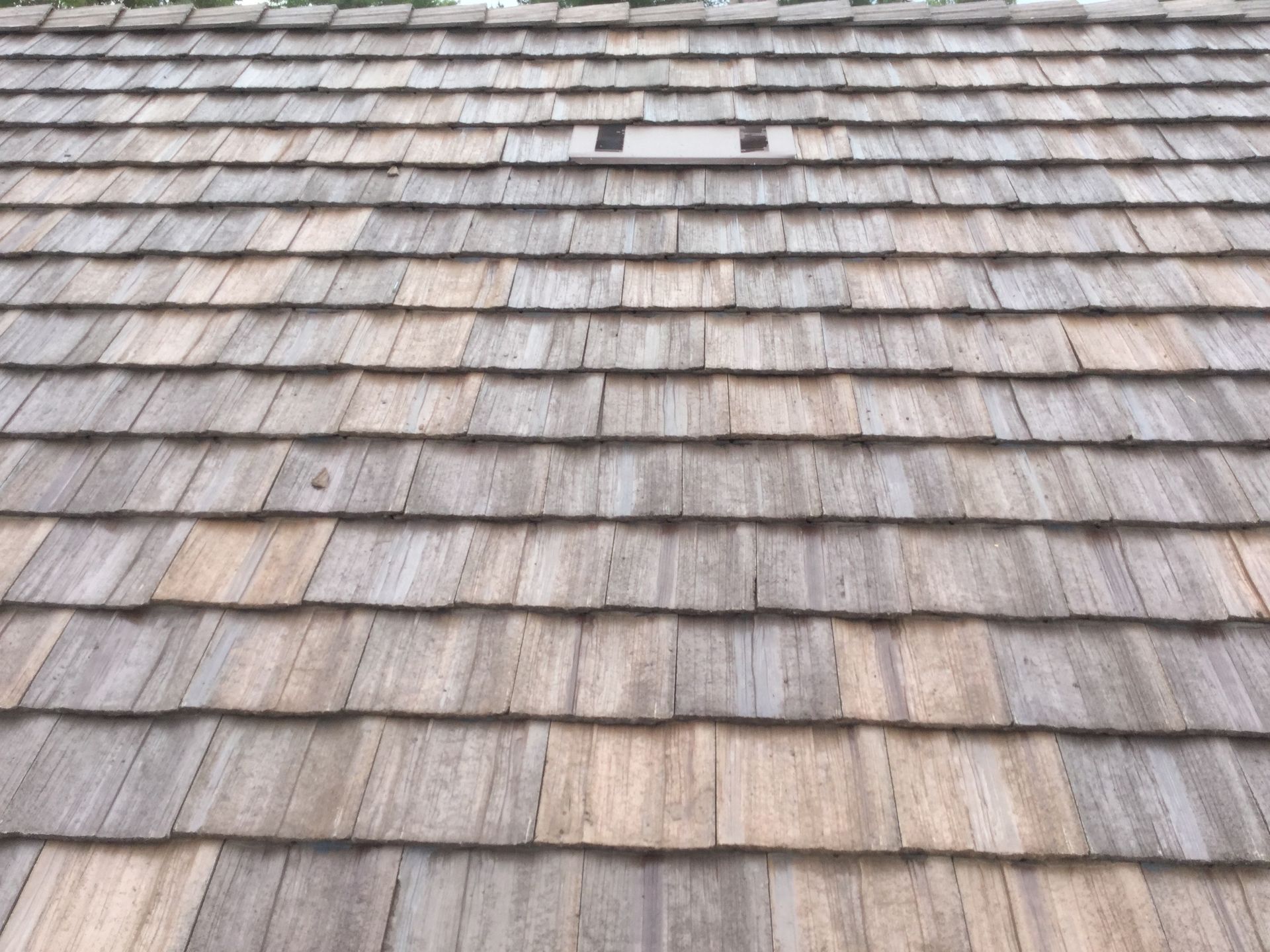 a close up of a wooden roof with shingles
