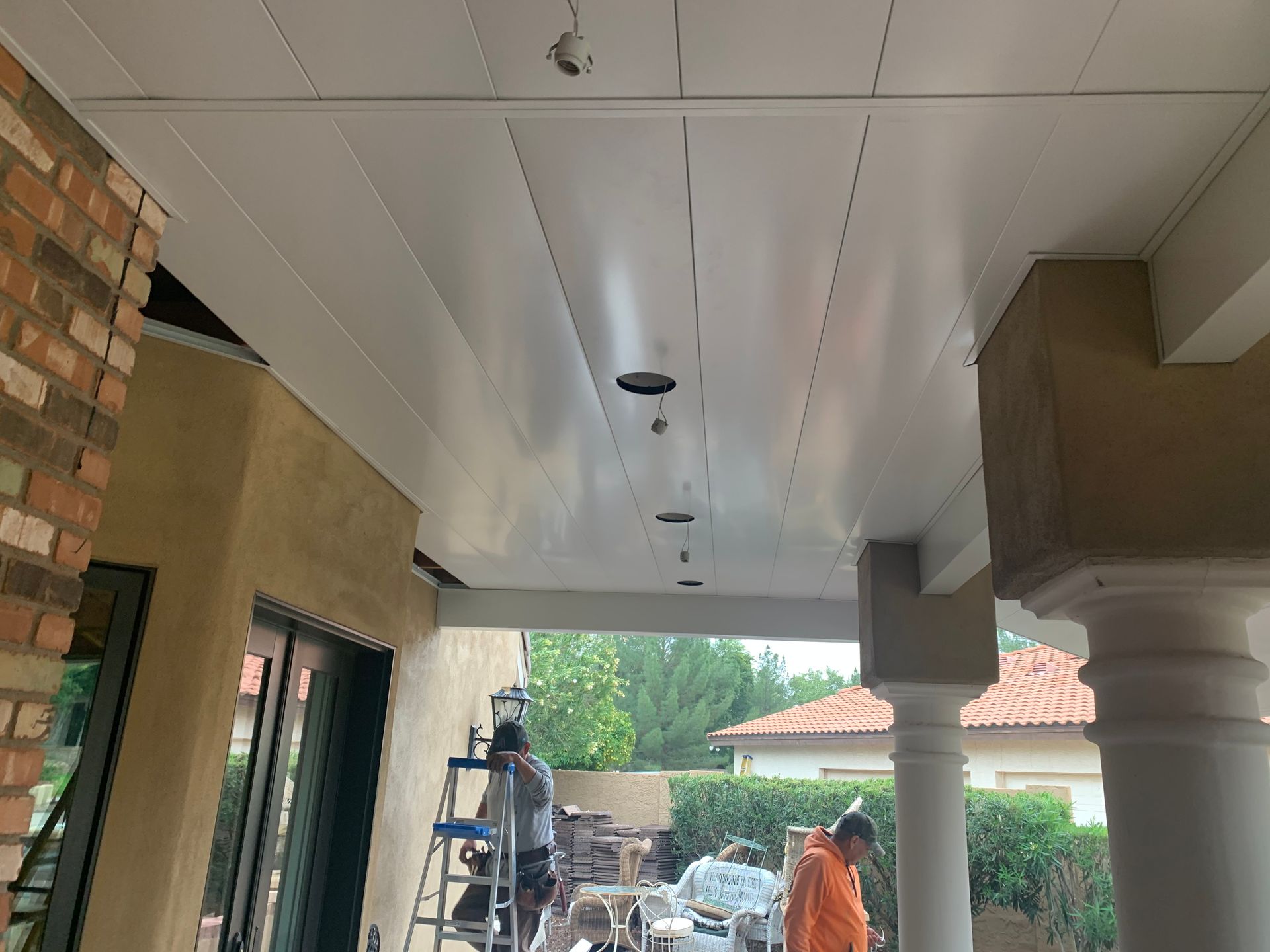 a group of people are working on the ceiling of a building