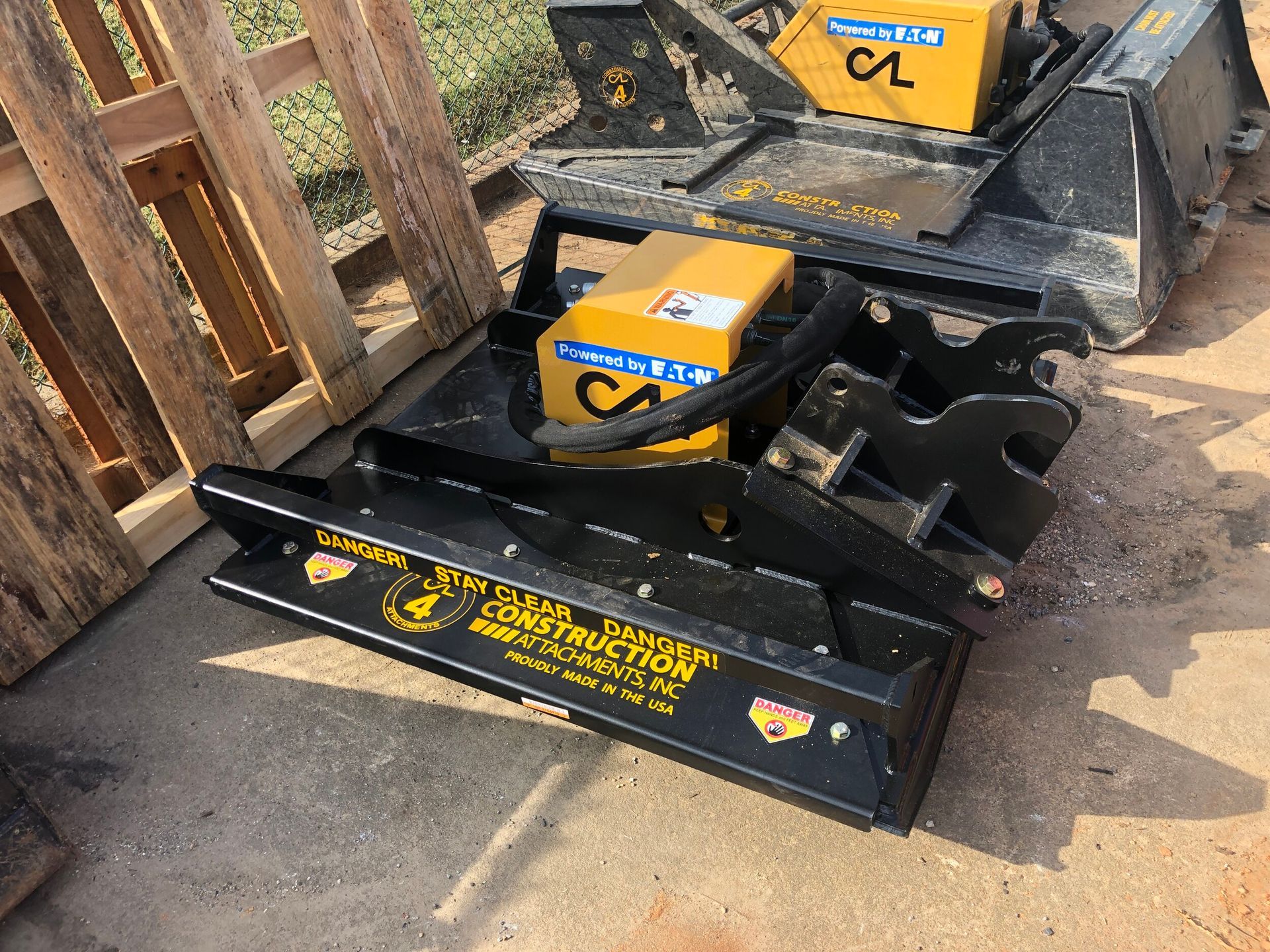 Black construction equipment with yellow boxes and the name of a construction company.
