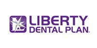 Liberty Dental Plan logo in purple with stylized star icon on white background