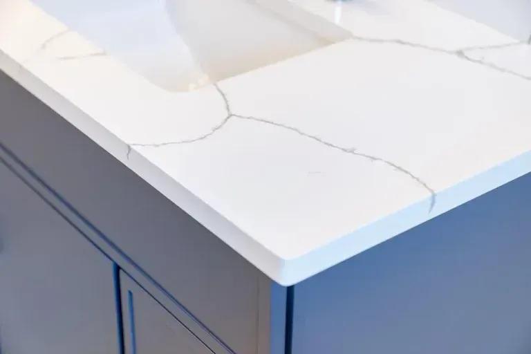 White cracked stone countertop on a blue-gray cabinet corner