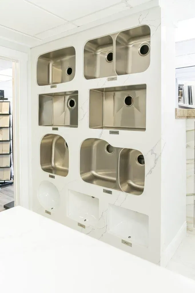 Wall of stainless steel pet kennels built into a white interior, some with doors open.