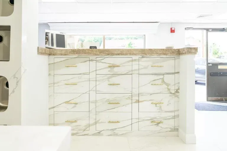 Modern bright lobby with a marble reception counter and glass doors in the background