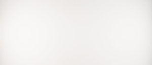 Mostly blank white image with a faint pink tint near the center and gray at the edges