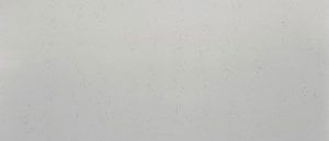 Blank light gray surface with a few faint specks and shadows.