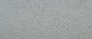 Close-up of a gray textured surface with faint dark speckles