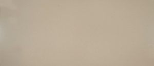 Close-up of a plain beige wall with a small dark spot near the center-left