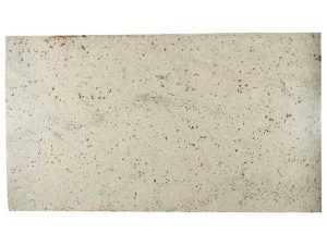 Off-white speckled textured surface with small dark flecks