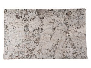 Close-up of a light gray and white speckled stone or textured surface