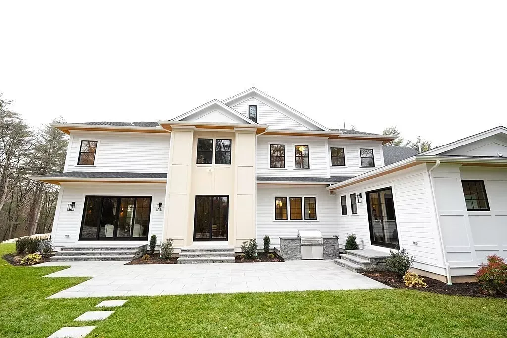 Large white two-story house with a front lawn and walkway