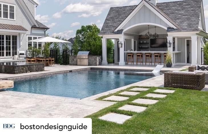 Luxury backyard pool with stone walkway, white pool cabana, and lounge chairs beside a house