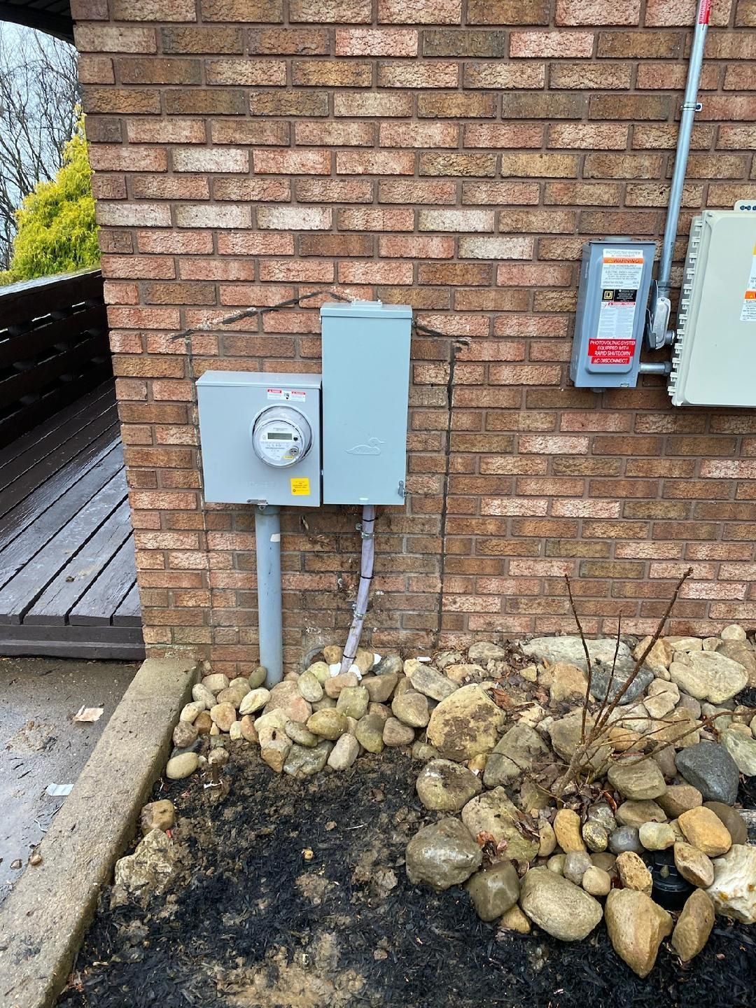 there is a meter on the side of a brick building .