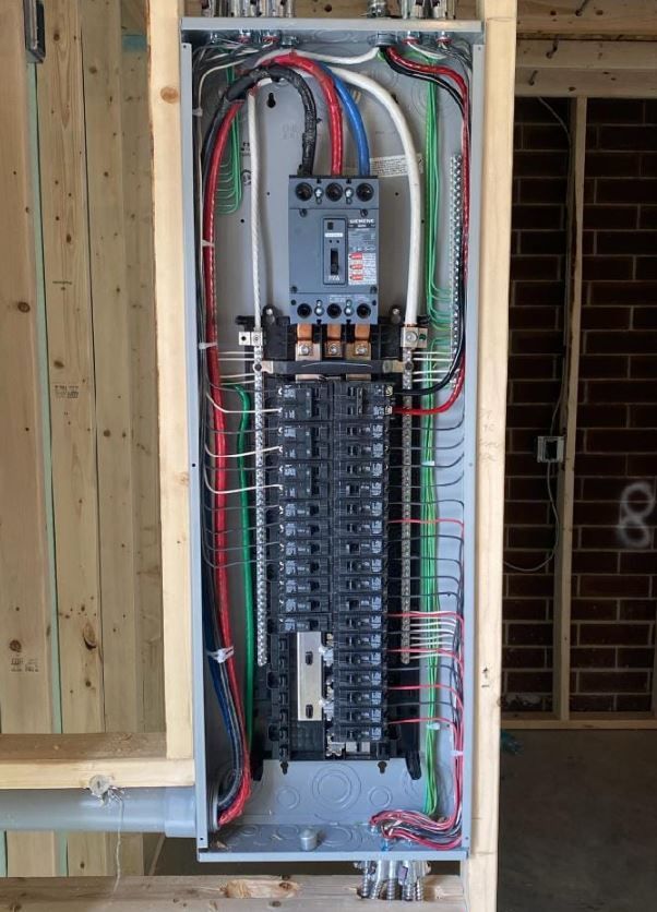An electrical box with a lot of wires coming out of it