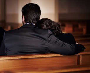 Mourning couple in black suit