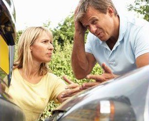 Man and blonde woman in car accident confilct