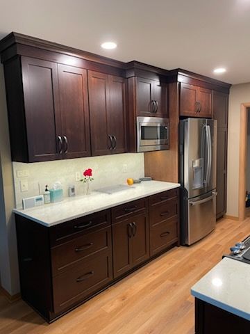 A kitchen with wooden cabinets and stainless steel appliances.