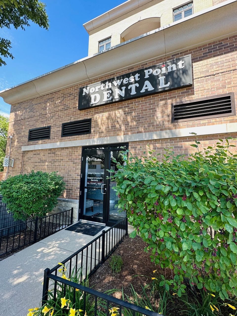 A brick building with a sign that says northwest point dental on it.