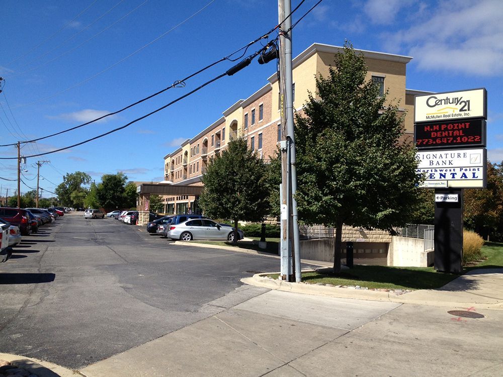 A parking lot with cars parked in front of a building