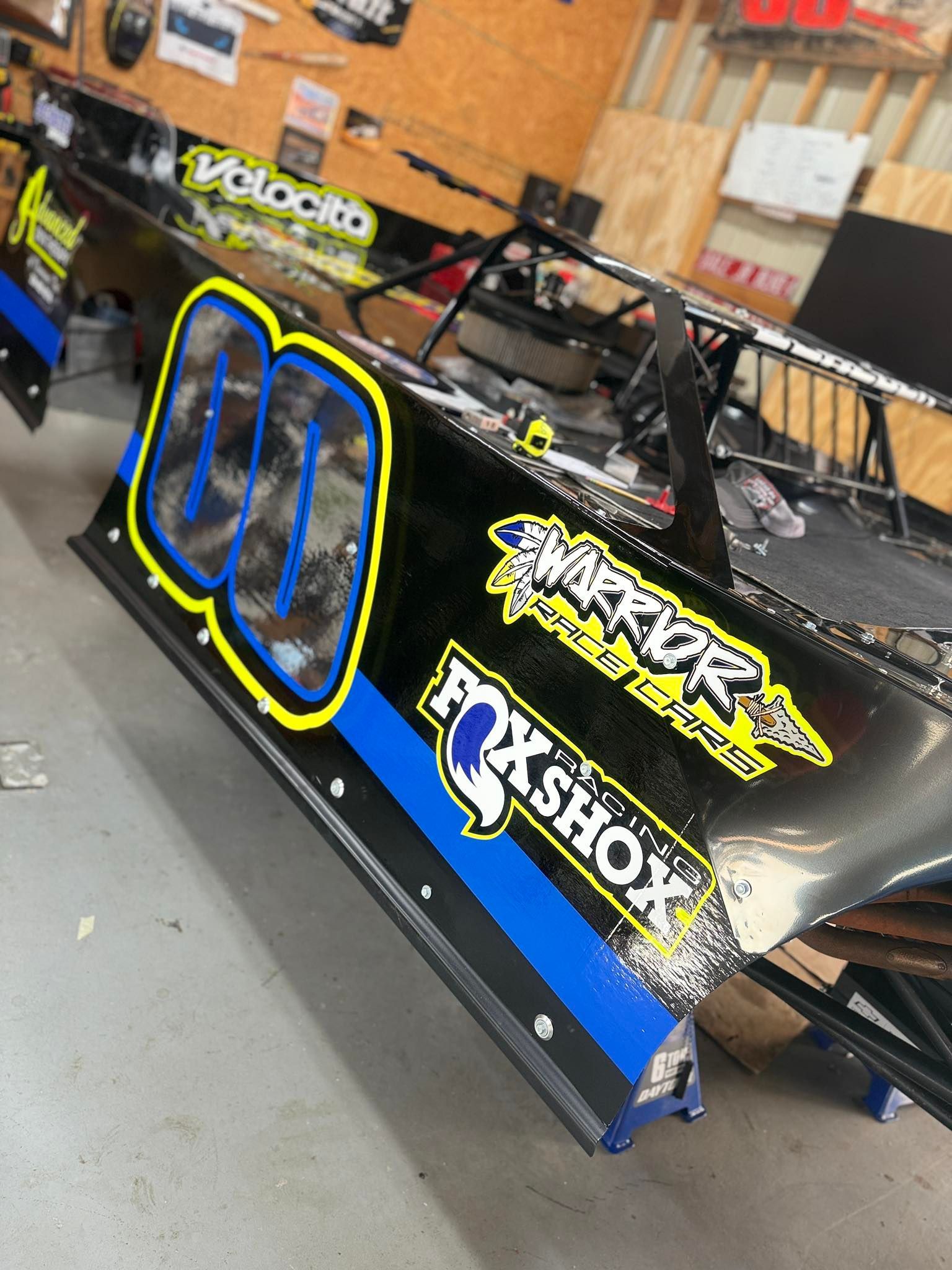 Black race car with blue and yellow accents