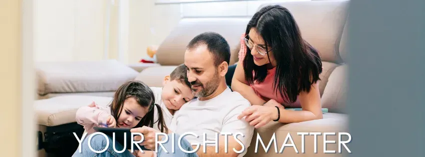 Family of four smiling at a tablet in a living room, text reads 