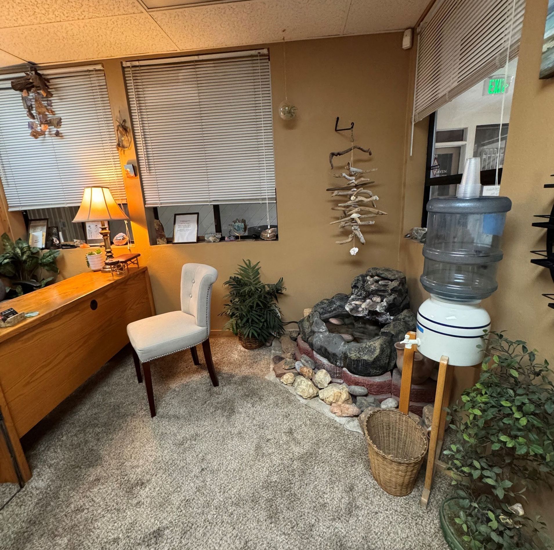 A room with a water cooler and a chair