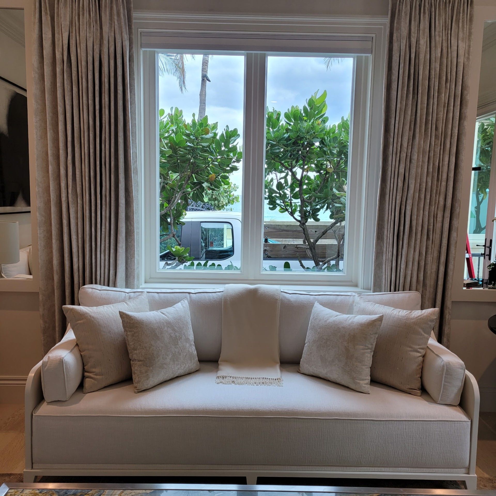 Person reupholstering a seat, stretching fabric over foam padding.