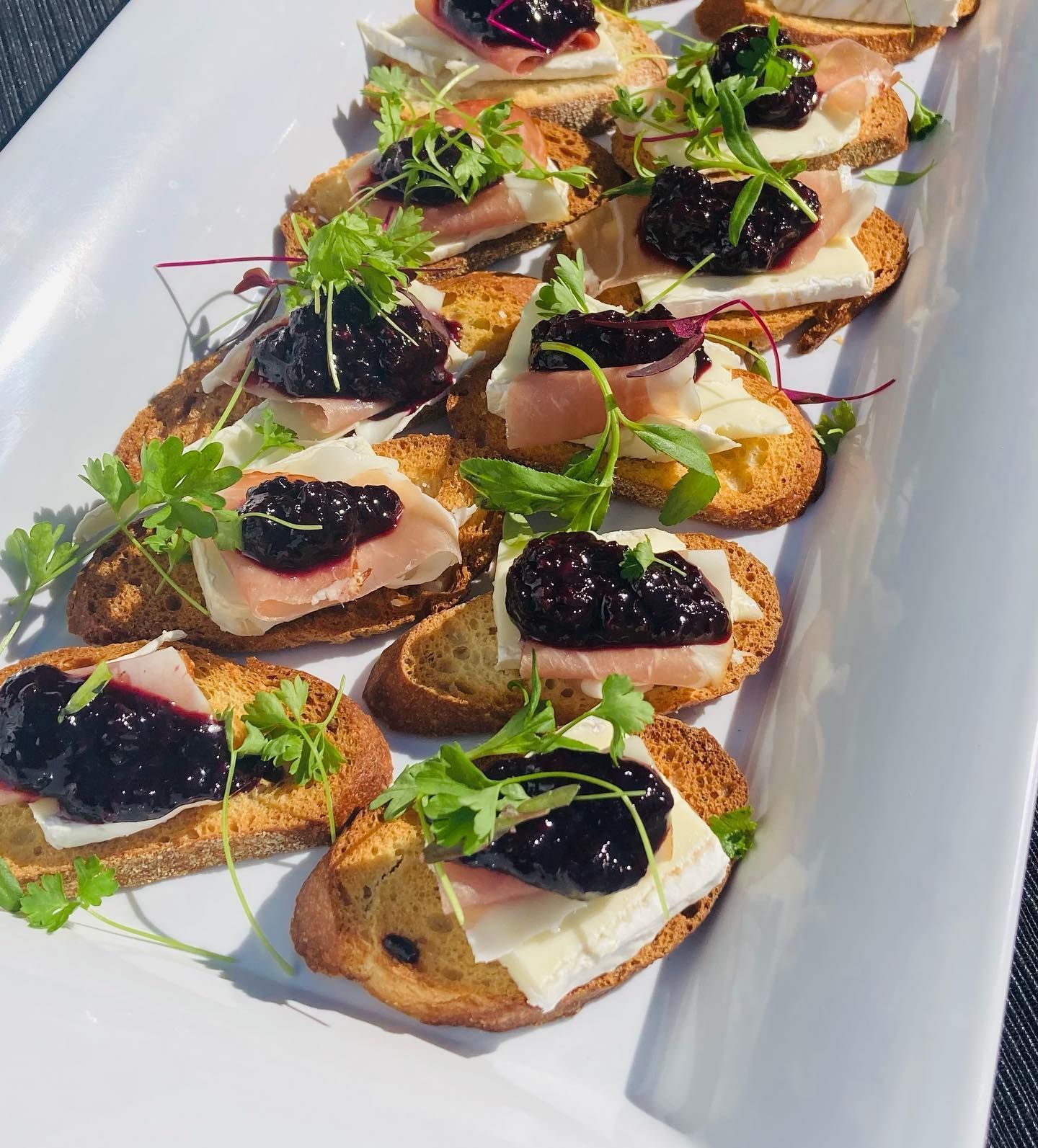 A white plate topped with a variety of appetizers